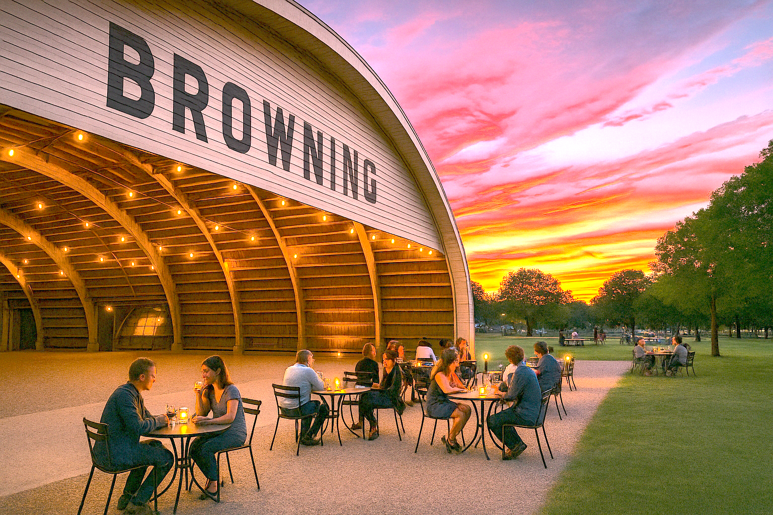 browning-hangar-community-evening People sitting and socializing inside the Browning Hangar during an evening gathering.